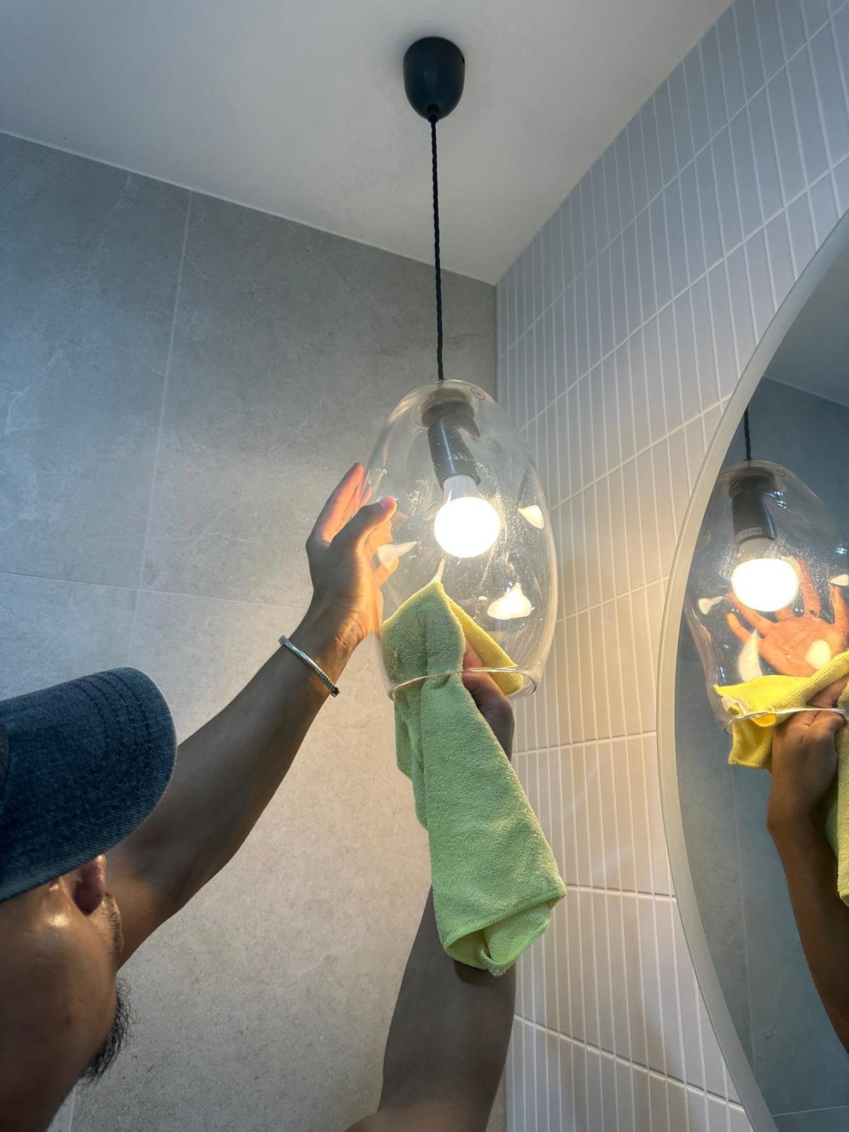 Cleaner detailing a glass pendant light
