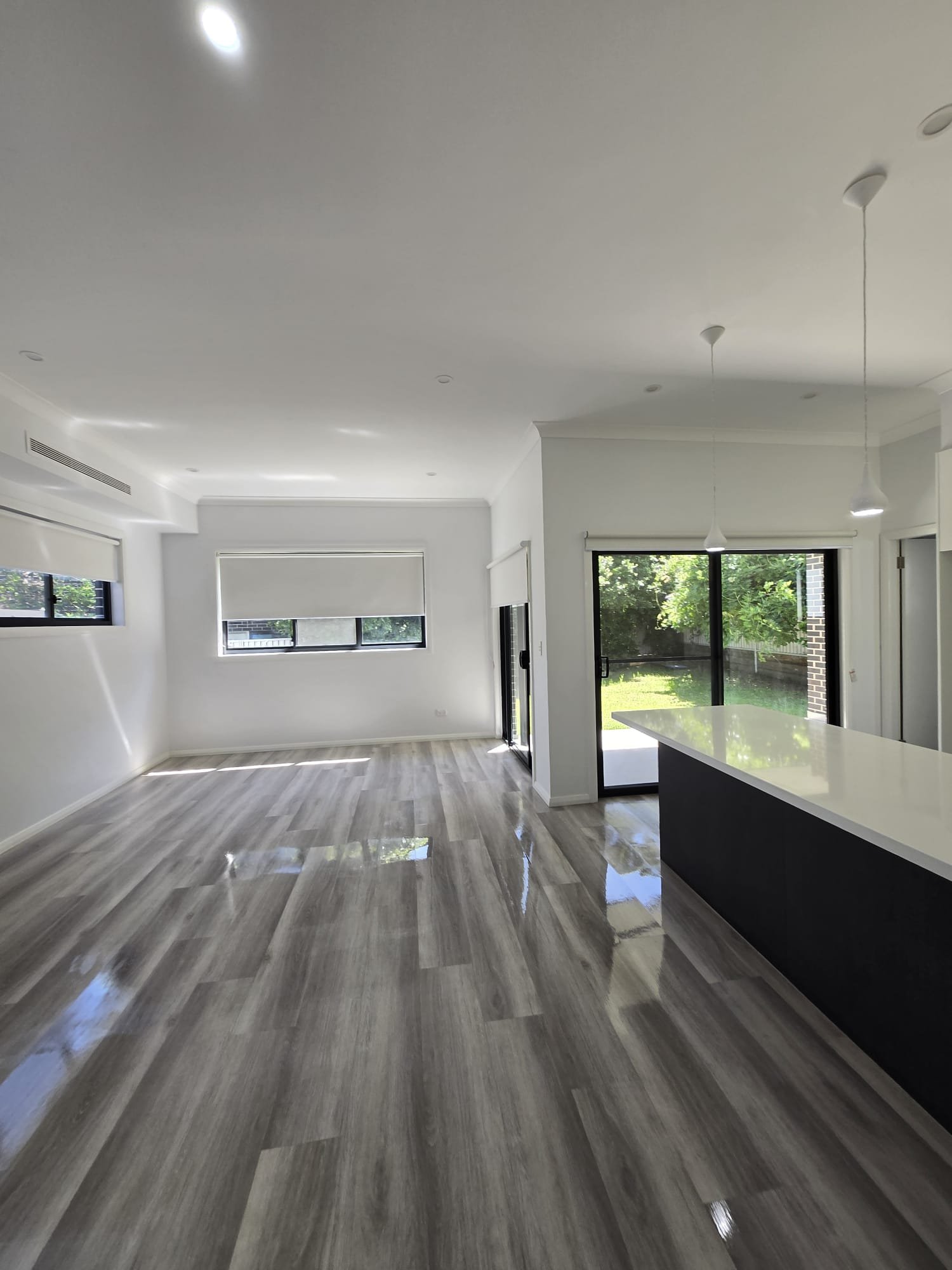 Bright open-plan living and kitchen with gleaming floors