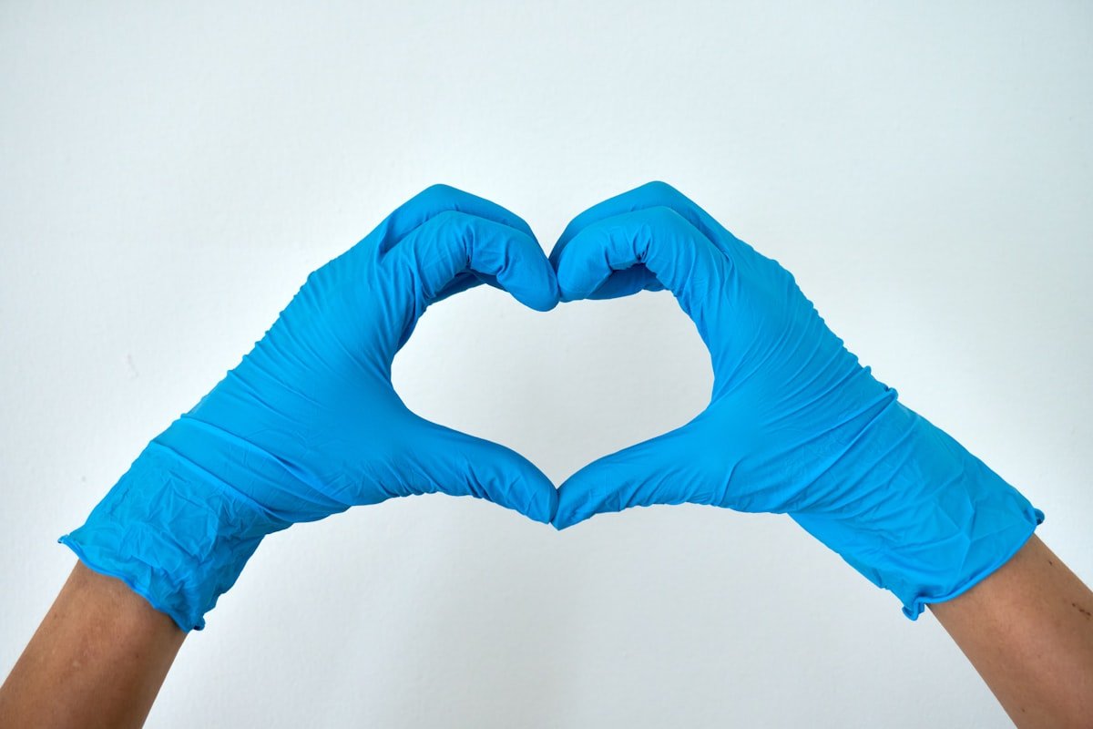 Cleaner's gloved hands forming a heart